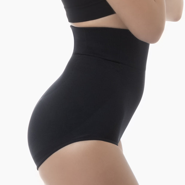 Right side view of women’s black high-waisted shapewear brief worn by model