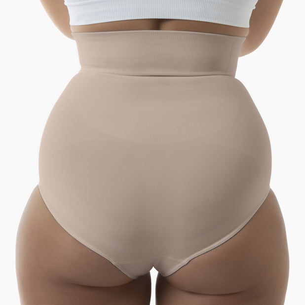 Back view of women’s powder high-waisted shapewear brief worn by model