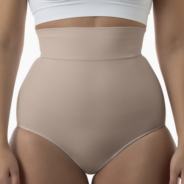 Front view of women’s powder high-waisted shapewear brief worn by model