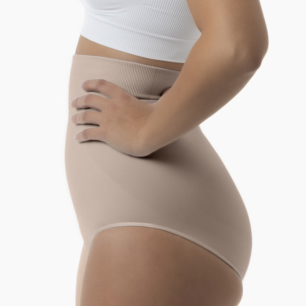 Left side view of women’s nude high-waisted shapewear brief worn by model