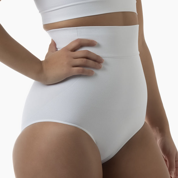 Right side view of women’s white high-waisted shapewear brief worn by model