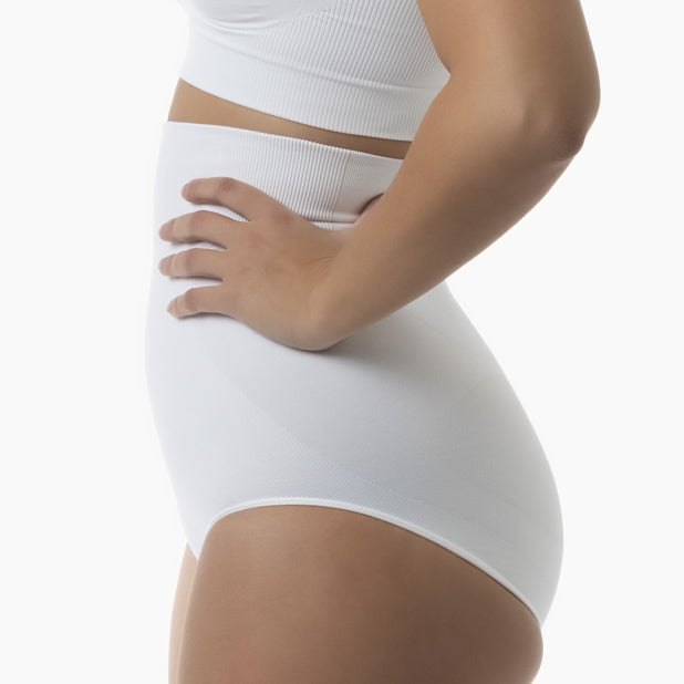 Left side view of women’s white high-waisted shapewear brief worn by model