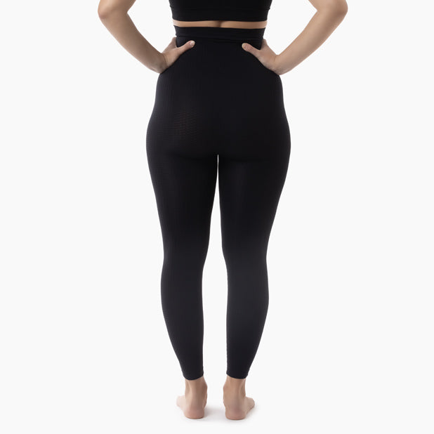Back view of women’s black high-waisted anti-cellulite leggings worn by model