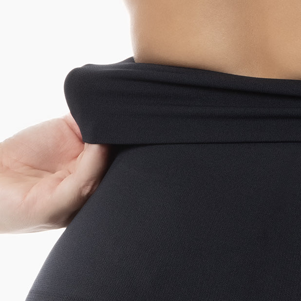 Detail of women’s black high-waisted tummy control leggings worn by model – product 609y