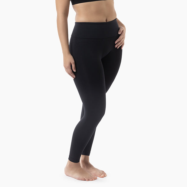 Right side view of women’s black high-waisted tummy control leggings worn by model – product 609y