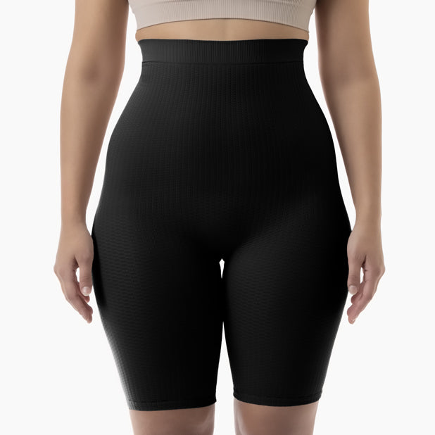 Front view of women’s black high-waist anti-cellulite shapewear shorts worn by model