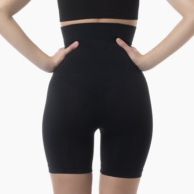 Back view of women’s black seamless shaping high waist shorts worn by model – product 603y