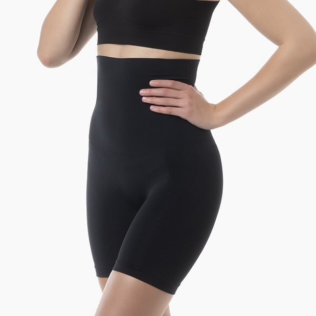 Right side view of women’s black seamless shaping high waist shorts worn by model – product 603y