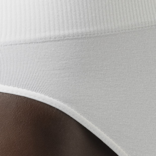 Detail of men’s white tummy control shapewear brief worn by model