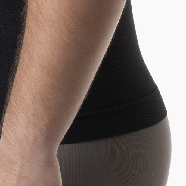Left detail view of men’s black slimming compression tank top worn by model – product 417b