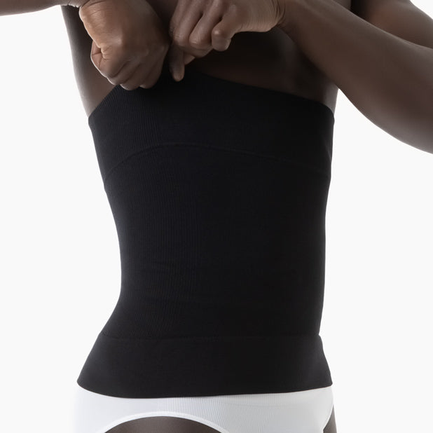 Right side view of men’s black shapewear waist cincher worn by model