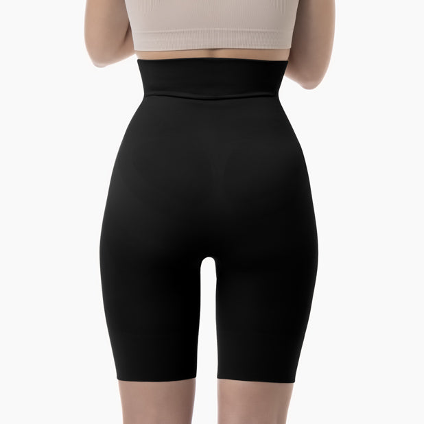 Back view of women’s black high-waist mid-thigh shapewear short worn by model