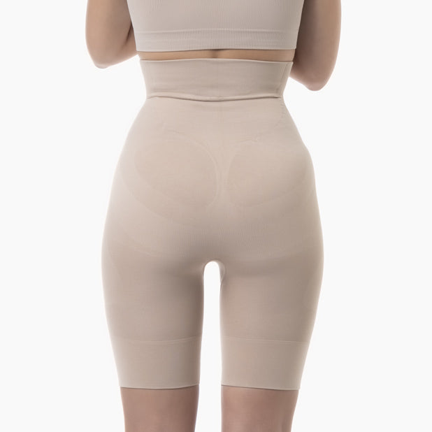 Back view of women’s powder high-waist mid-thigh shapewear short worn by model
