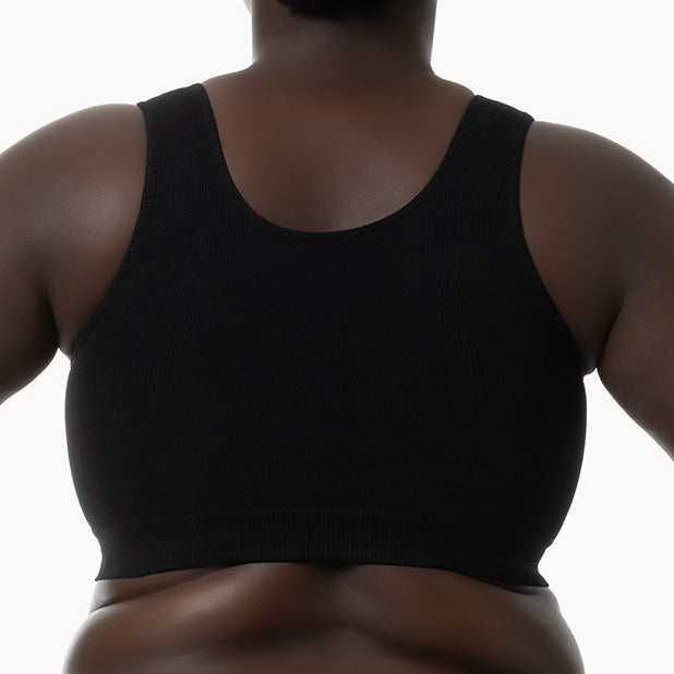 Back view of black shapewear bra with wide shoulder straps worn by curvy model