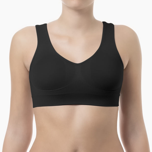 Front view of black shapewear bra with wide shoulder straps worn by model