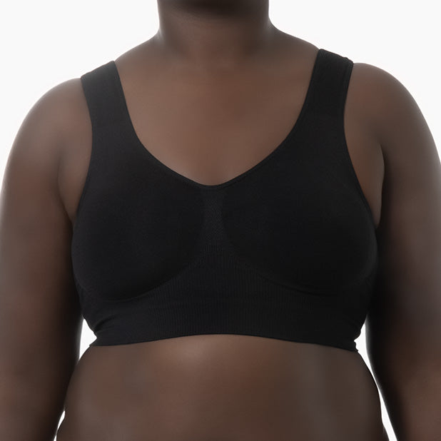 Front view of black shapewear bra with wide shoulder straps worn by curvy model