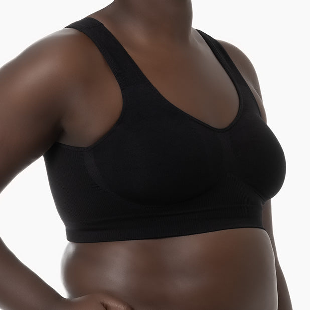 Right side view of black shapewear bra with wide shoulder straps worn by curvy model