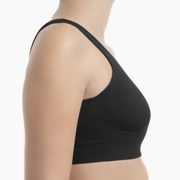 Right side view of black shapewear bra with wide shoulder straps worn by model