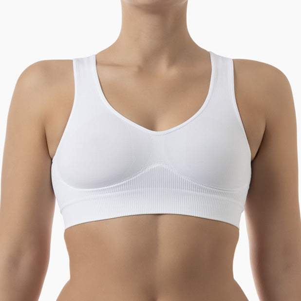 Front view of white shapewear bra with wide shoulder straps worn by model
