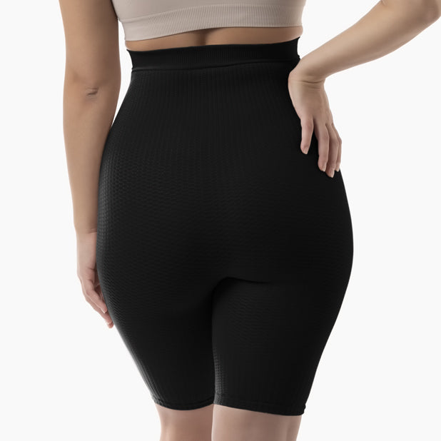 Back view of women’s black high-waist anti-cellulite shapewear shorts worn by model