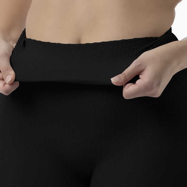 detail of women’s black high-waist anti-cellulite shapewear shorts worn by model