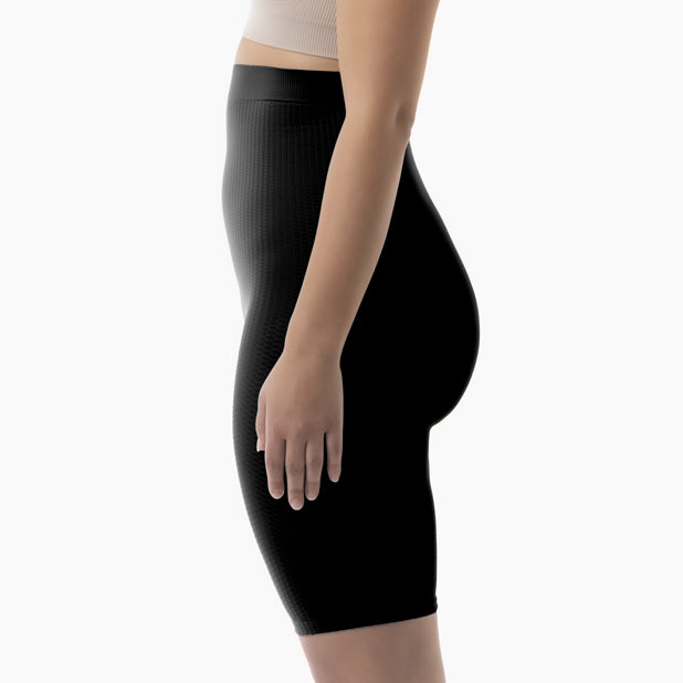 Left side view of women’s black high-waist anti-cellulite shapewear shorts worn by model