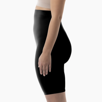 Left side view of women’s black high-waist anti-cellulite shapewear shorts worn by model