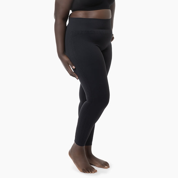 Left side view of women’s grey anti-cellulite compression leggings worn by curvy model – product 1109